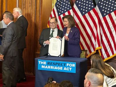 Jerry Nadler and Nancy Pelosi are holding and showing the Respect for Marriage Act bill.